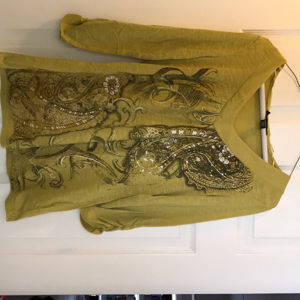 Olive green shirt, with cool design on the front.